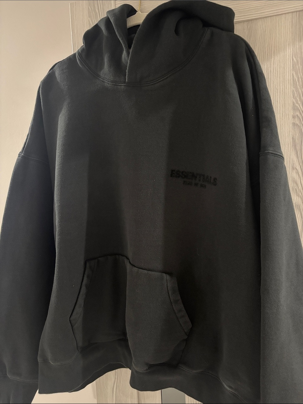 Essentials Black Pullover Hoodie with Subtle Chest Logo